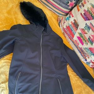 Marmot jacket with fleece fur  lining and fur trim around the hood.
